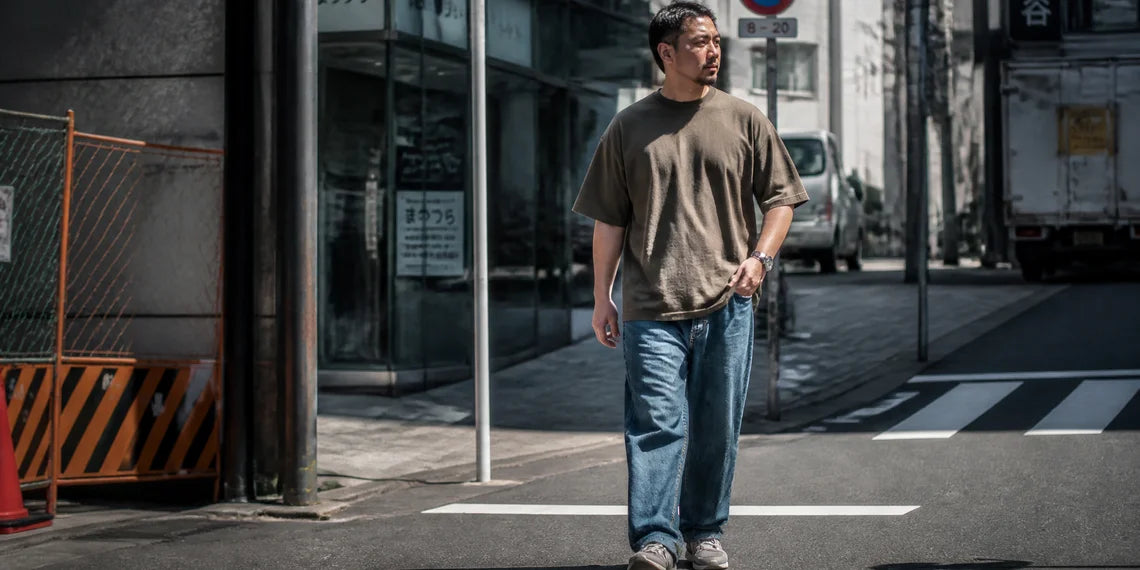 A stylish chubby man showcasing modern Japanese aesthetic oversized outfit street fashion.