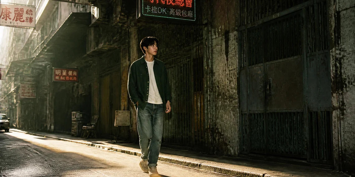 A stylish young man walking in the street wearing vintage Hong Kong style outfits.