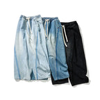 FLOW系列黑色抽繩氣球牛仔褲正面近照，細緻的拼接車縫線展現工匠級做工細節